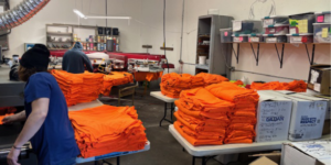 bulk custom t-shirts stacked and ready to be boxed.